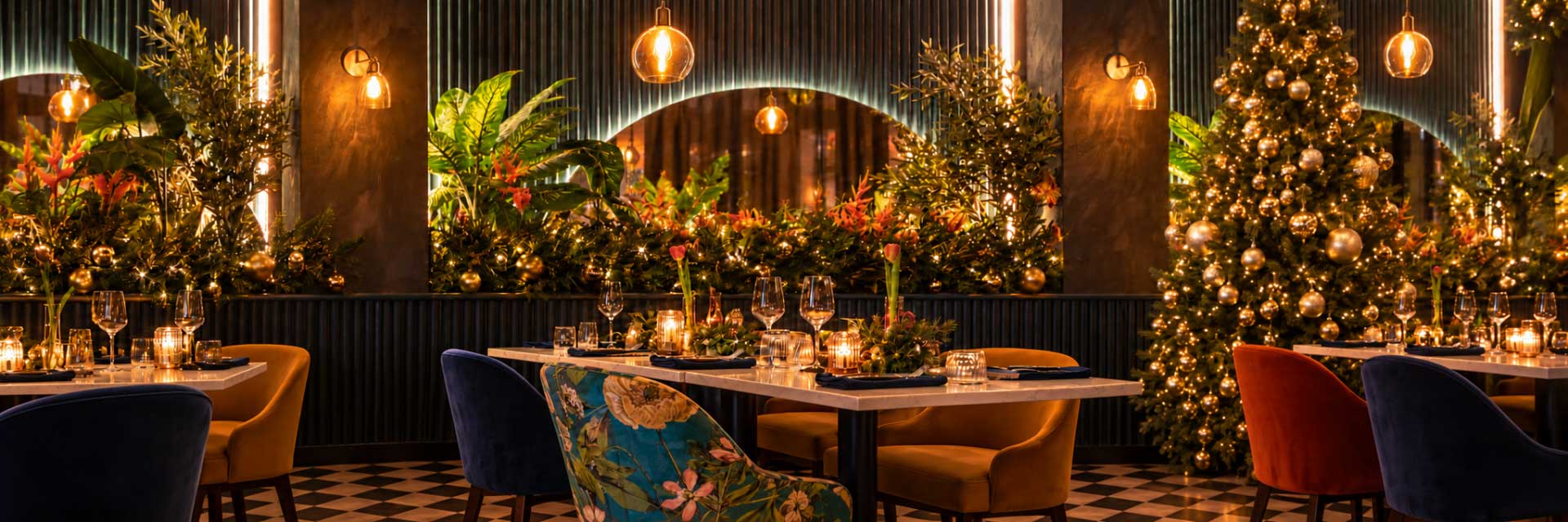 Beleza Rodizio dining room decorated for Christmas with a gold-baubled tree and candlelit tables
